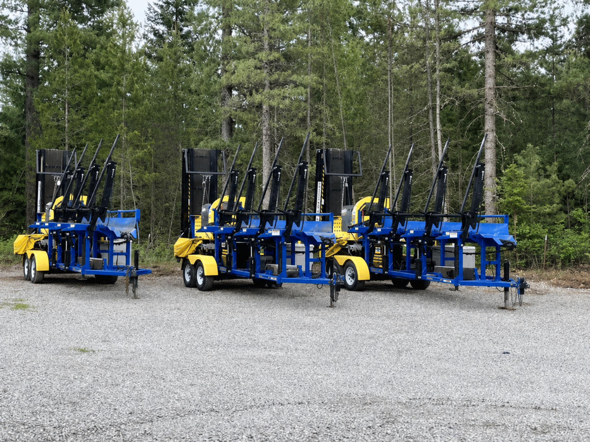 DYNA SC-15 firewood processors parked side by side on a gravel lot, ready to rent