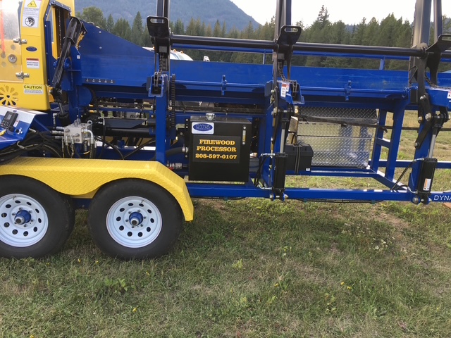 Close-up of the processor trailer frame with the Panhandle Firewood Processor placard