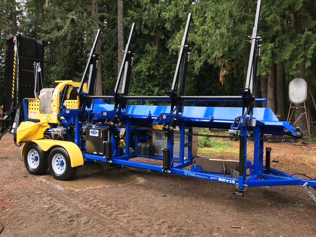 DYNA SC-15 firewood processor with its log deck extended, parked in the yard